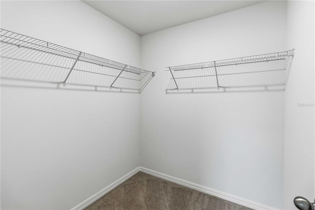 4571 Range Land Way St. Cloud, FL 34772 - Photo 19 of 43 a view of a room with racks on the wall