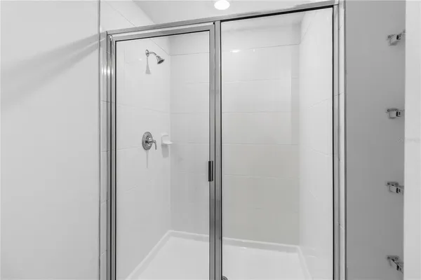 a bathroom with a glass shower door
