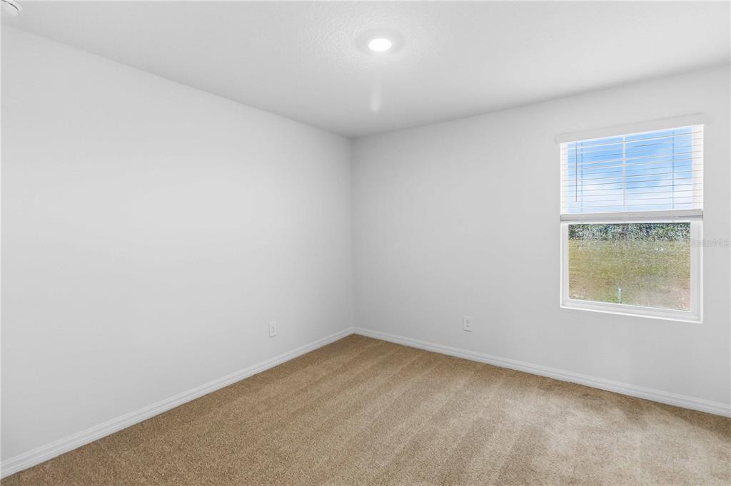 4571 Range Land Way St. Cloud, FL 34772 - Photo 23 of 43 an empty room with a window