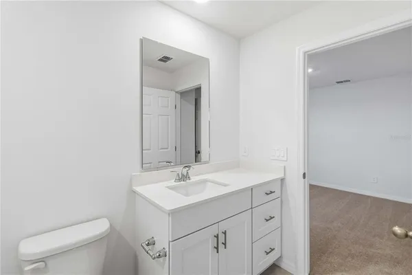 a bathroom with a sink toilet and mirror