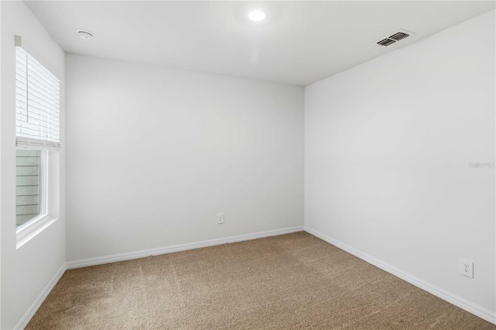 4571 Range Land Way St. Cloud, FL 34772 - Photo 27 of 43 a view of an empty room and a window