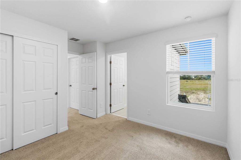 4571 Range Land Way St. Cloud, FL 34772 - Photo 28 of 43 a view of an empty room with a window