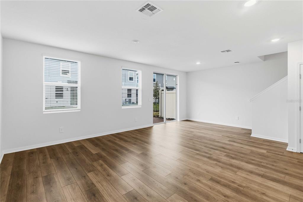 4571 Range Land Way St. Cloud, FL 34772 - Photo 5 of 43 a view of empty room with wooden floor and fan
