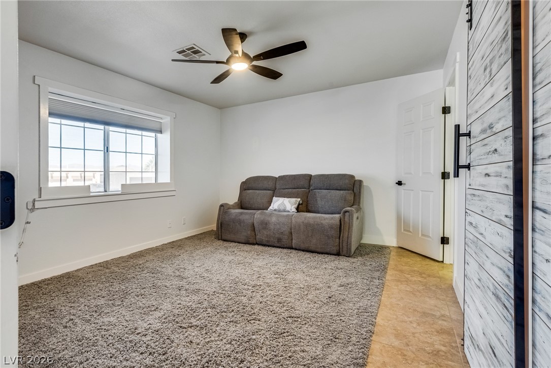 524 Swallow Cove Boulder City, NV 89005 - Photo 28 of 58 A versatile secondary room offers soft carpeting, a bright window, and an efficient ceiling fan.