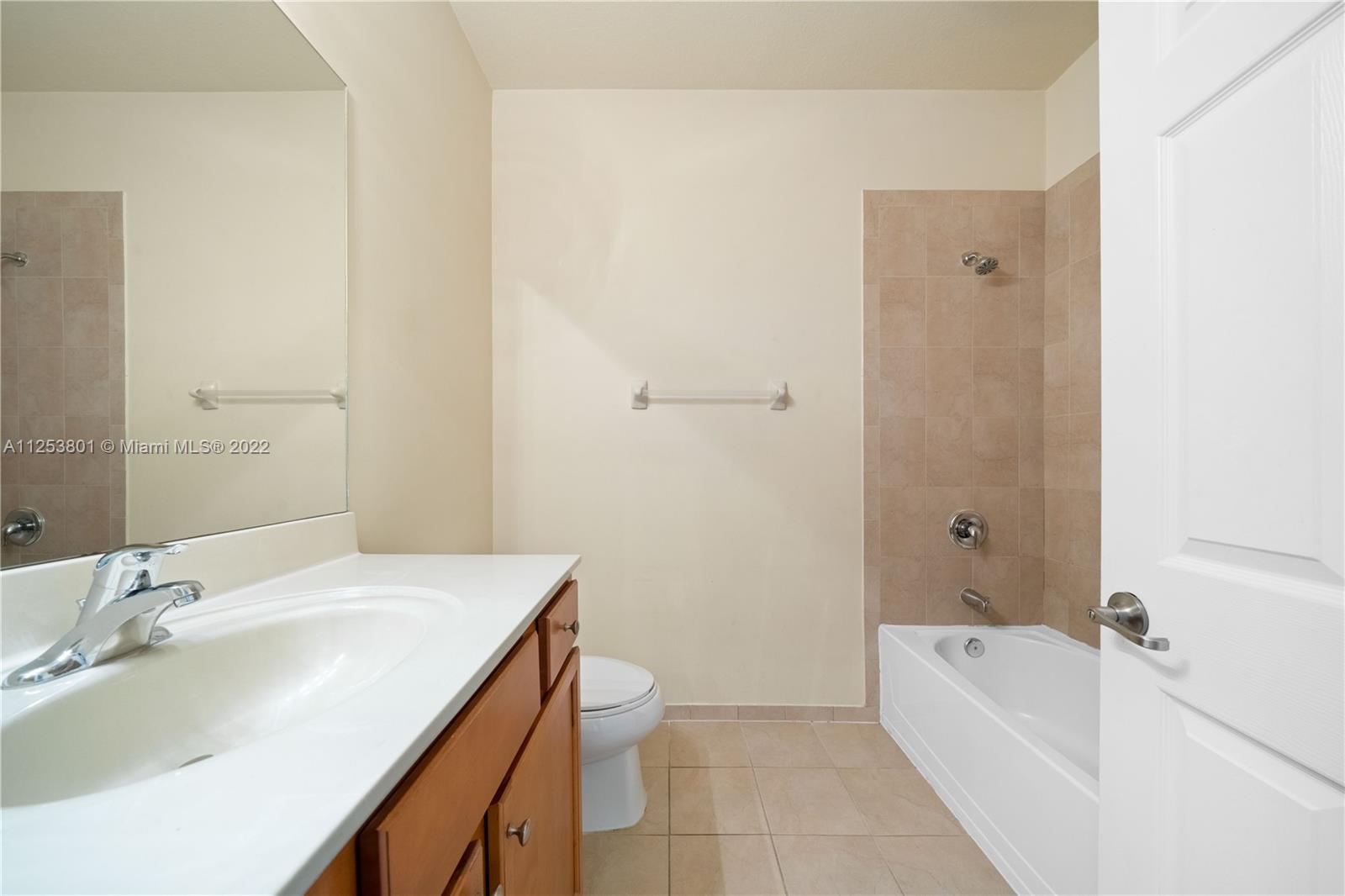 3366 West 90th Terrace, Unit 3366 Hialeah, FL 33018 - Photo 22 of 26 a bathroom with a granite countertop sink a toilet and bathtub