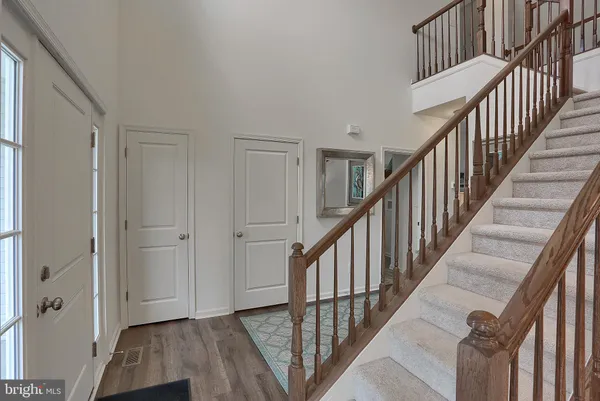 a view of entryway and hall with wooden floor