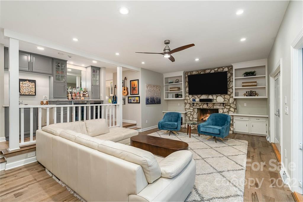 4525 Rounding Run Road Charlotte, NC 28277 - Photo 12 of 44 a living room with furniture a flat screen tv and a refrigerator