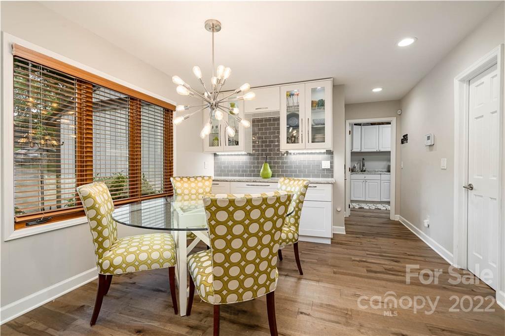 4525 Rounding Run Road Charlotte, NC 28277 - Photo 16 of 44 a dining room with furniture a chandelier and wooden floor