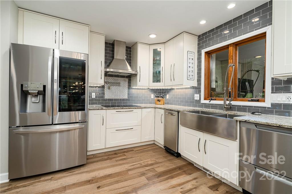4525 Rounding Run Road Charlotte, NC 28277 - Photo 19 of 44 a kitchen with stainless steel appliances granite countertop a refrigerator a sink and white cabinets with wooden floor
