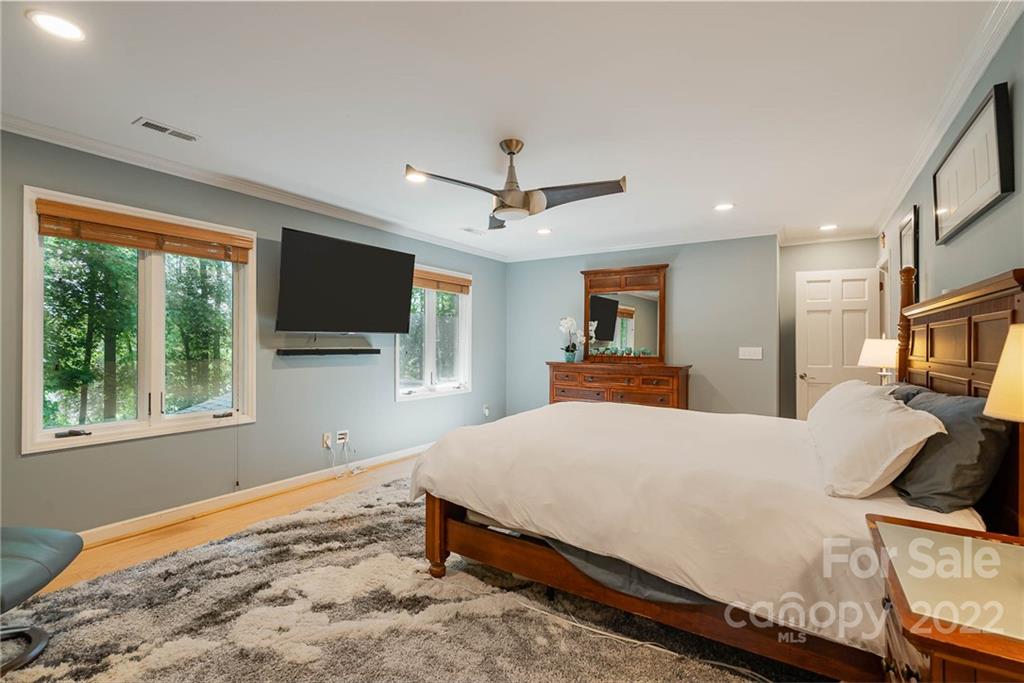 4525 Rounding Run Road Charlotte, NC 28277 - Photo 20 of 44 a living room with a bed furniture flat screen tv and a large window