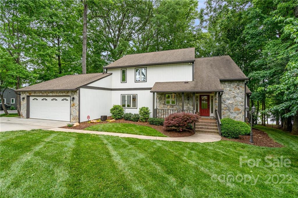 4525 Rounding Run Road Charlotte, NC 28277 - Photo 2 of 44 a front view of a house with a garden and plants