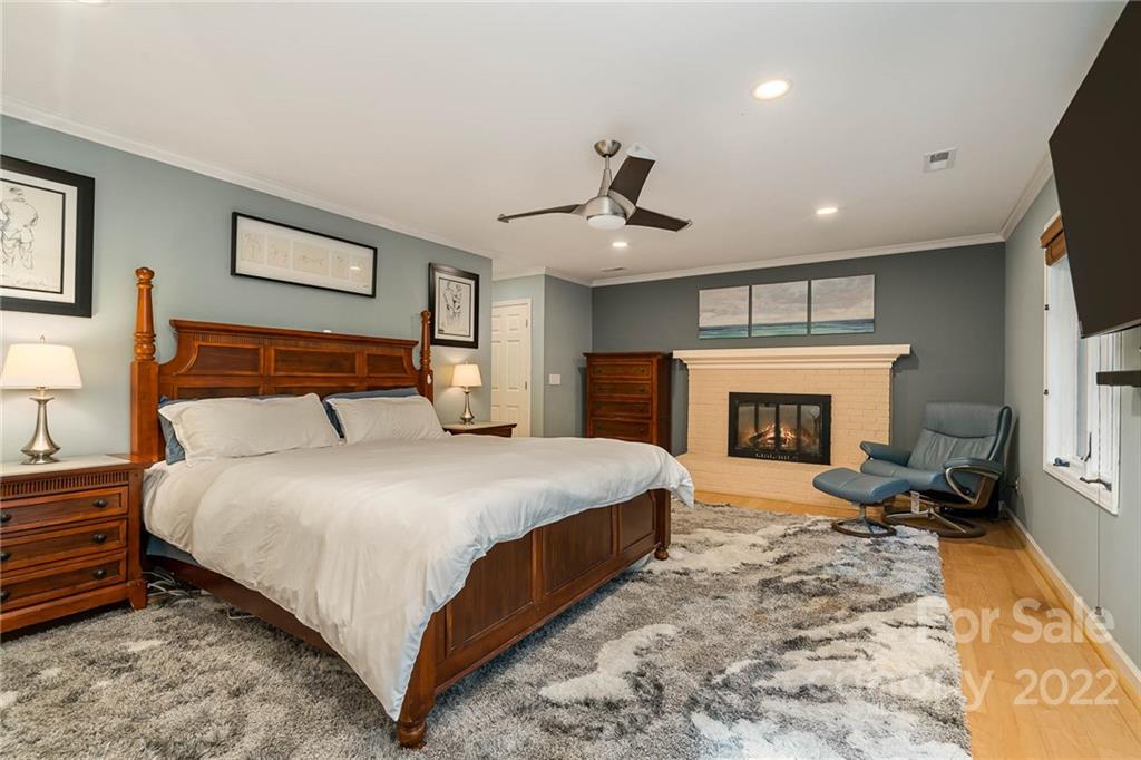 4525 Rounding Run Road Charlotte, NC 28277 - Photo 21 of 44 a large bedroom with a bed and a fireplace