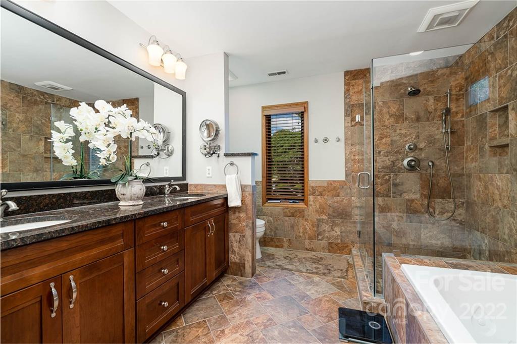 4525 Rounding Run Road Charlotte, NC 28277 - Photo 23 of 44 a spacious bathroom with a granite countertop sink mirror and shower