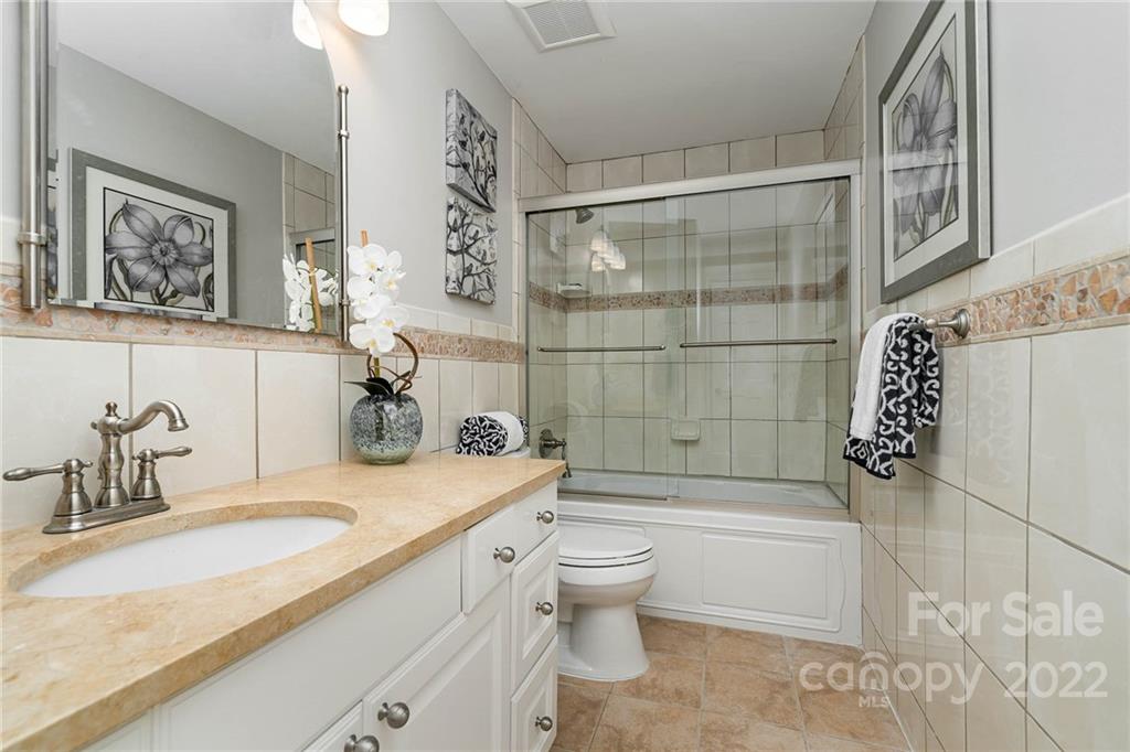 4525 Rounding Run Road Charlotte, NC 28277 - Photo 28 of 44 a bathroom with a granite countertop sink mirror toilet and bathtub