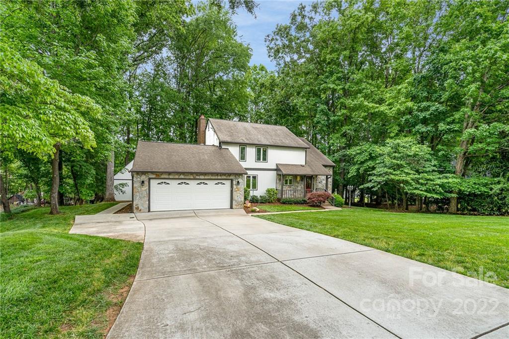 4525 Rounding Run Road Charlotte, NC 28277 - Photo 4 of 44 a front view of a house with a yard and trees