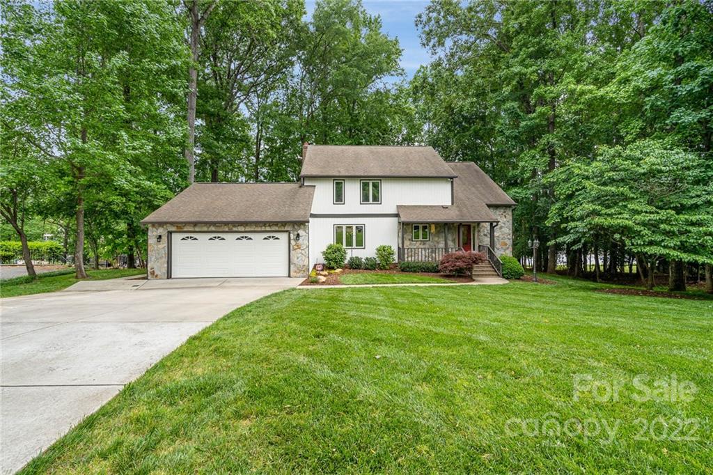 4525 Rounding Run Road Charlotte, NC 28277 - Photo 5 of 44 a front view of a house with a garden and trees