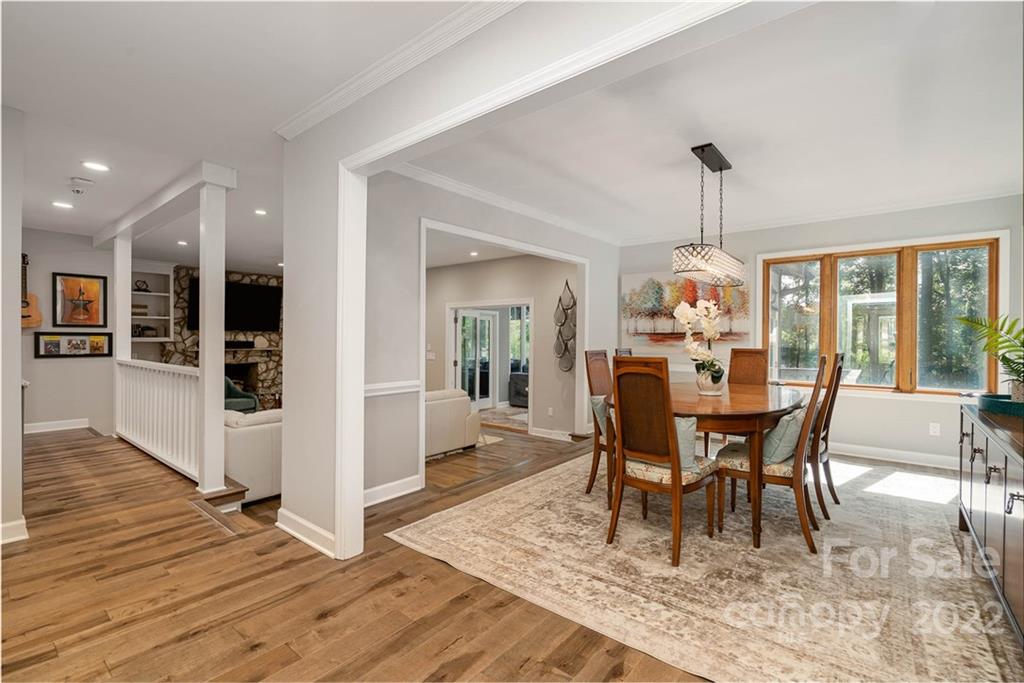 4525 Rounding Run Road Charlotte, NC 28277 - Photo 10 of 44 a dining room with furniture wooden floor a rug and a chandelier