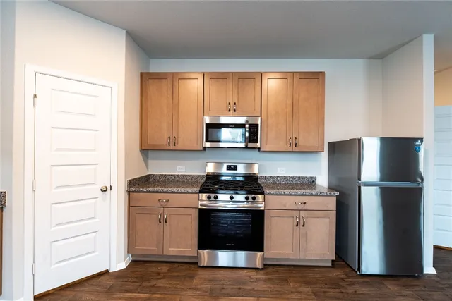 a kitchen with a stove and a refrigerator