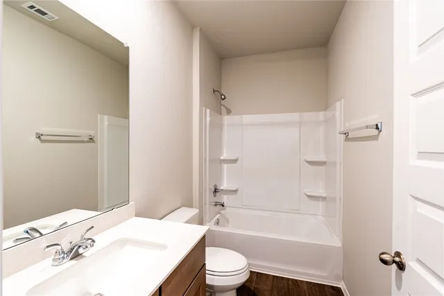 a bathroom with a sink a toilet and a bathtub