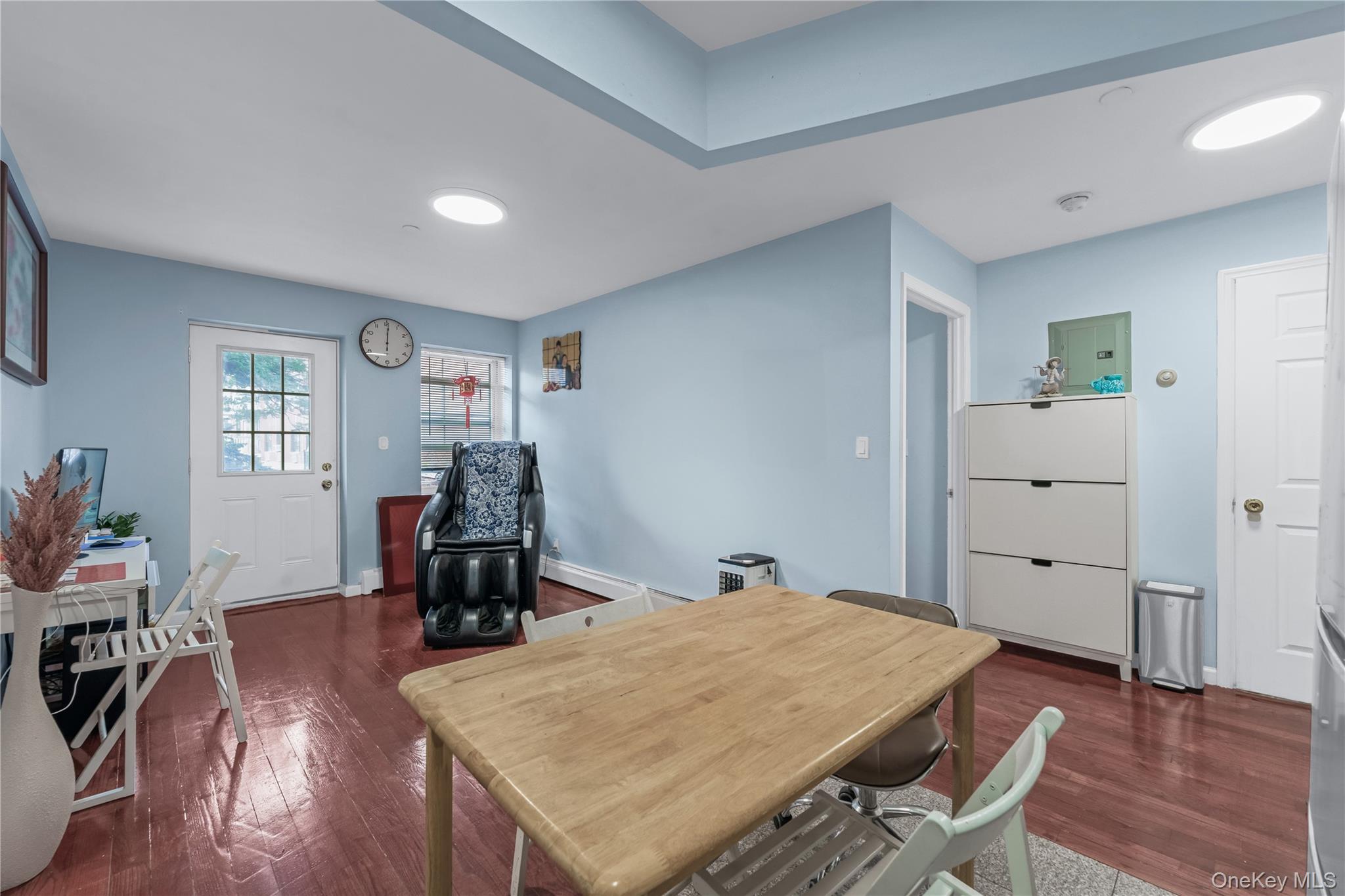 35-06 Leavitt Street, Unit 3K Queens, NY 11354 - Photo 5 of 17 Office area featuring dark wood-style flooring and a baseboard radiator