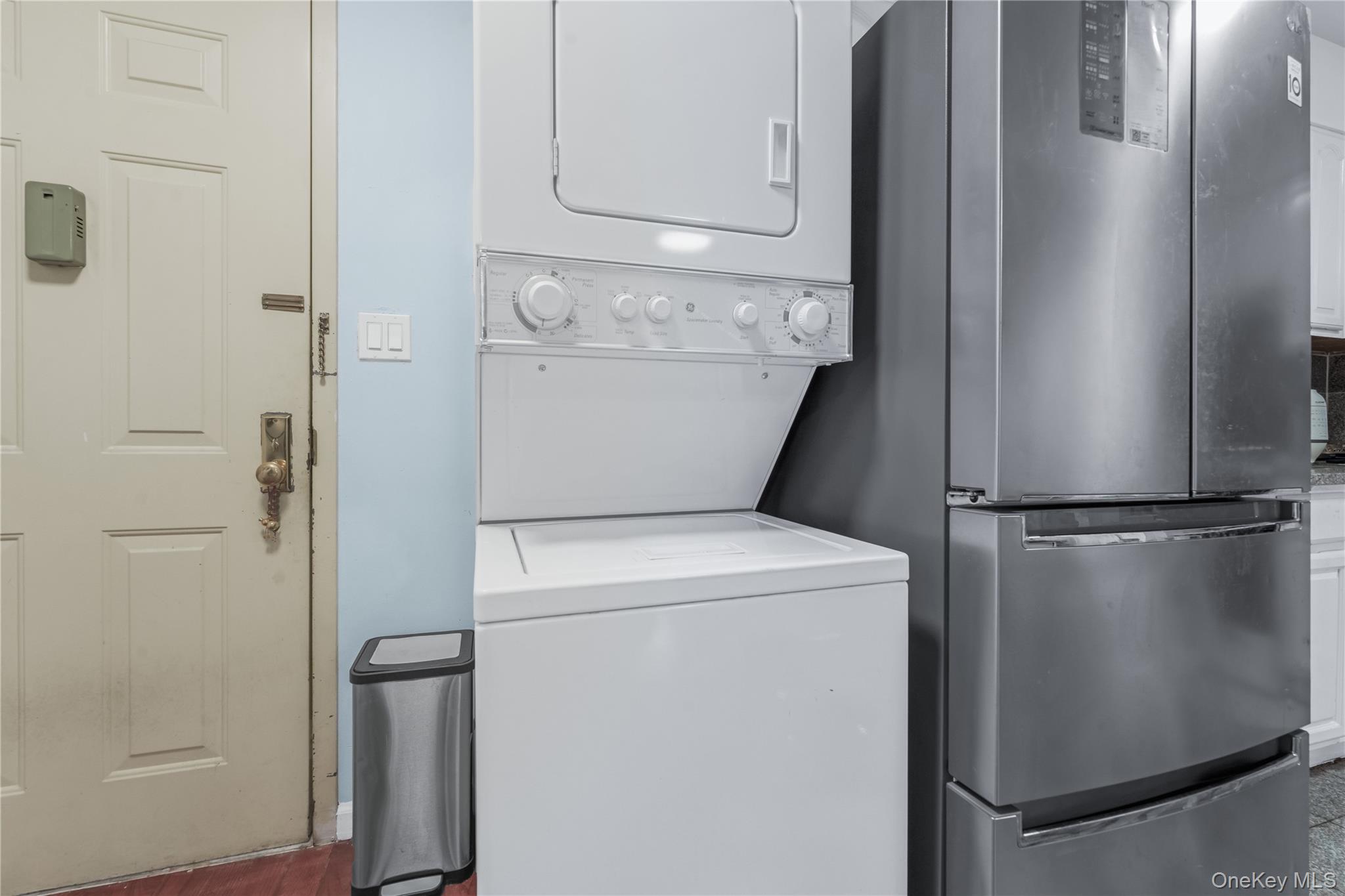 35-06 Leavitt Street, Unit 3K Queens, NY 11354 - Photo 6 of 17 Washroom featuring stacked washer / drying machine and wood finished floors