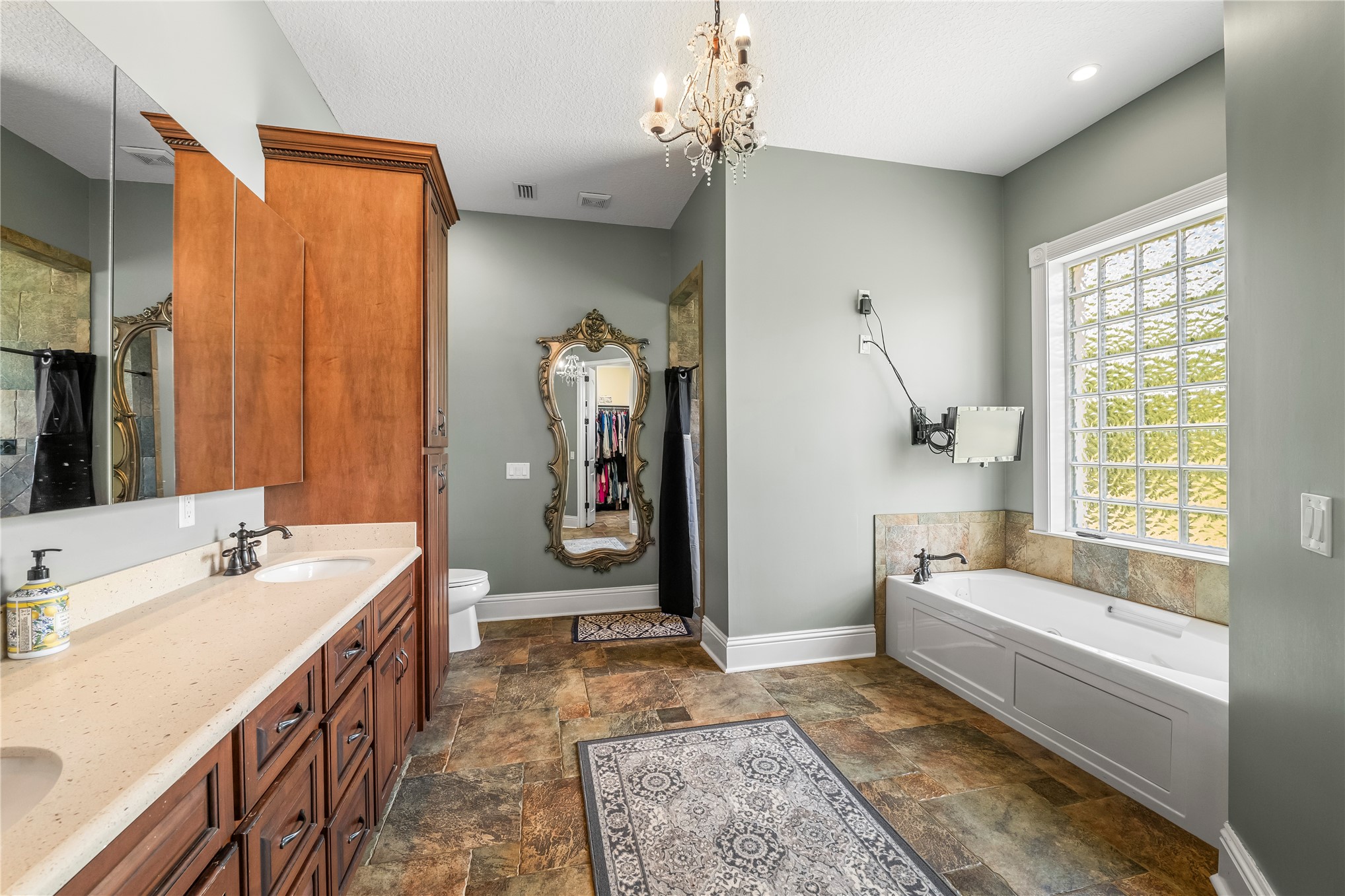 27247 Hallman Road Hilliard, FL 32046 - Photo 30 of 59 a bathroom with a tub a sink and a large mirror