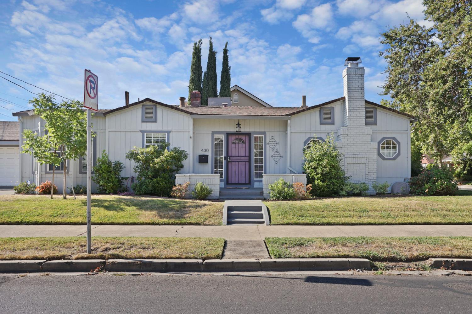 430 Bedford Road Stockton, CA 95204 - Photo 1 of 1 a front view of a house with a garden and plants