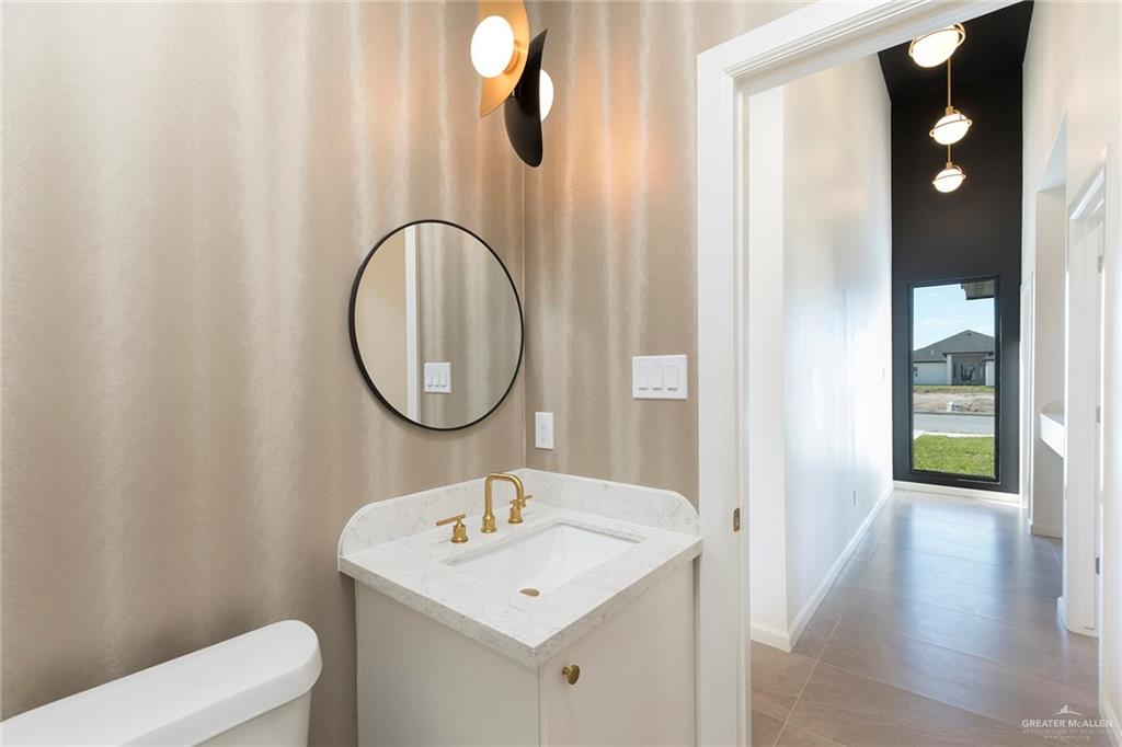 301 North 32nd Street Hidalgo, TX 78557 - Photo 12 of 22 a bathroom with a sink a toilet and a mirror