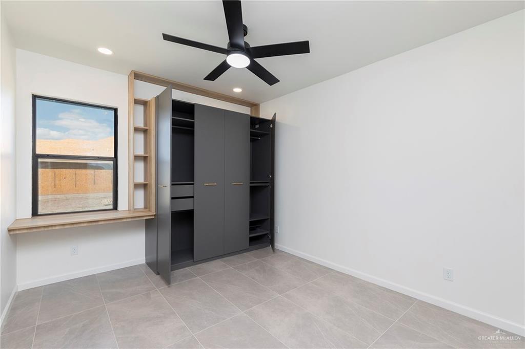 301 North 32nd Street Hidalgo, TX 78557 - Photo 14 of 22 an empty room with a ceiling fan and window