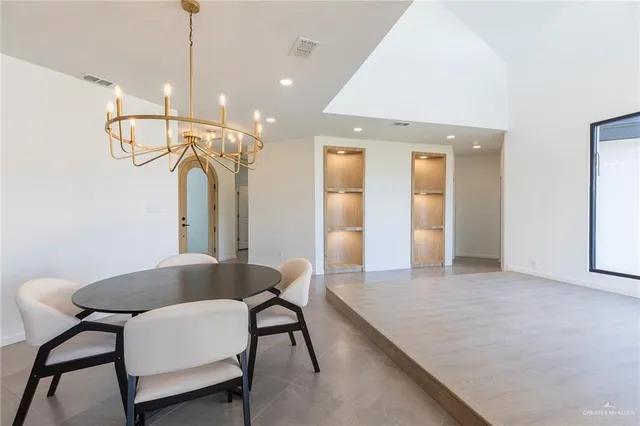 a view of a room with furniture and a chandelier