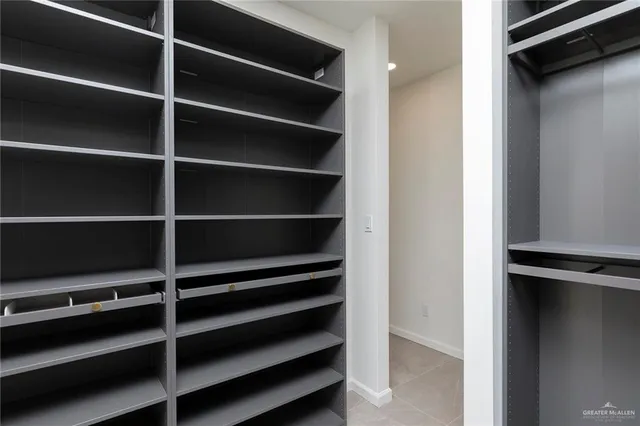 an empty room with closet and windows