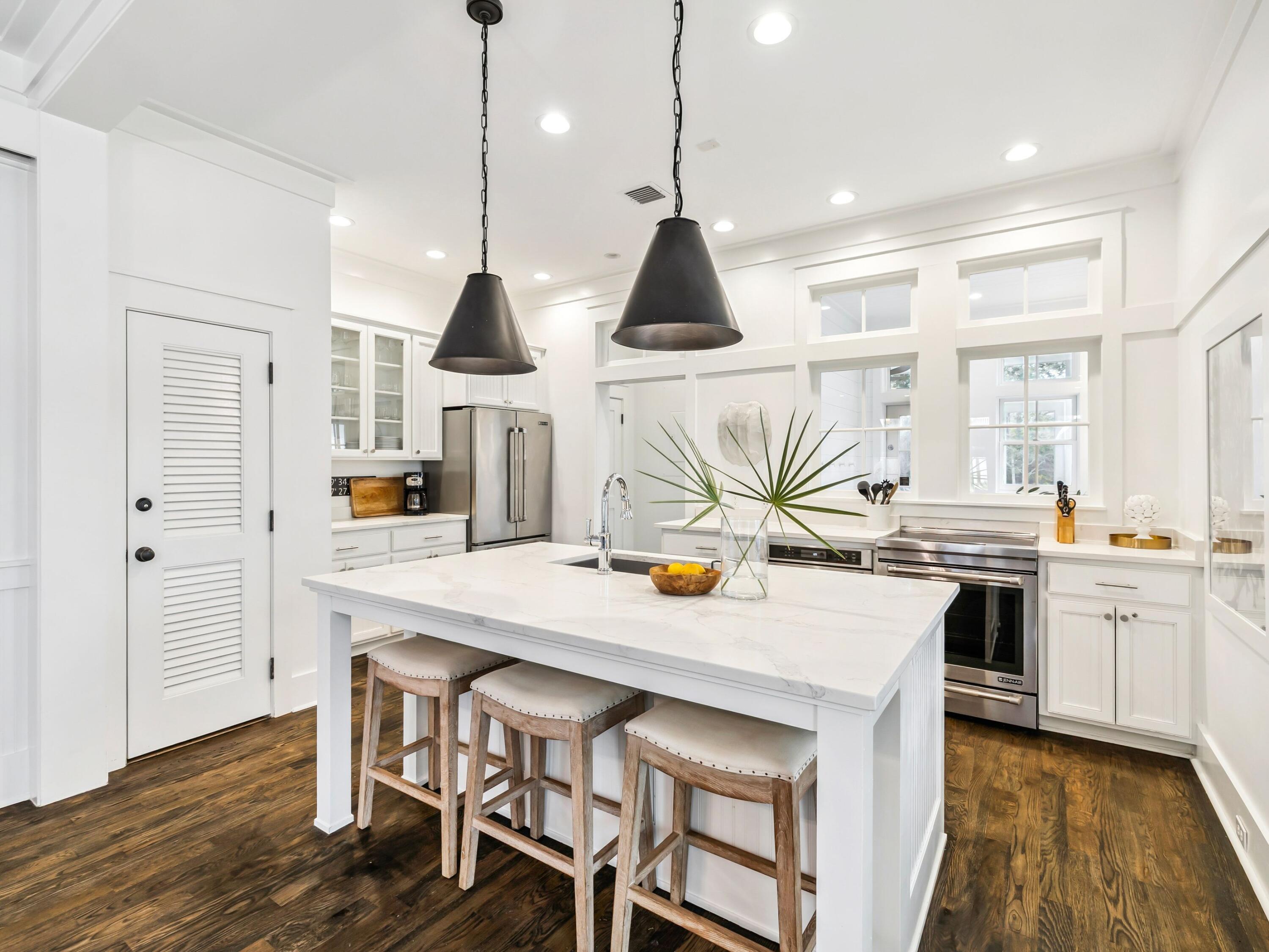 37 Winterberry Circle Santa Rosa Beach, FL 32459 - Photo 3 of 39 a kitchen with stainless steel appliances kitchen island granite countertop a stove a sink and a dining table with white cabinets