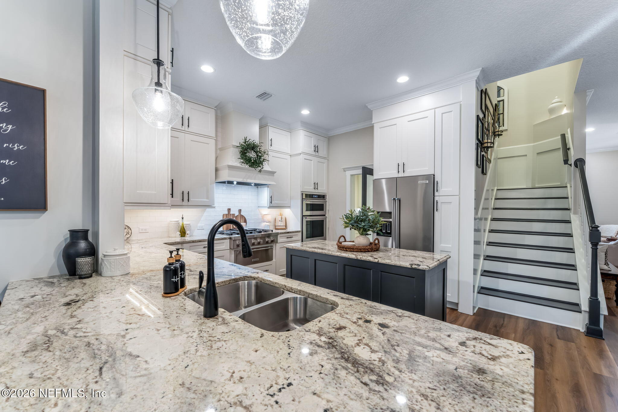 1204 Creek Bend Road St. Johns, FL 32259 - Photo 24 of 107 a kitchen with stainless steel appliances kitchen island granite countertop a sink and a refrigerator
