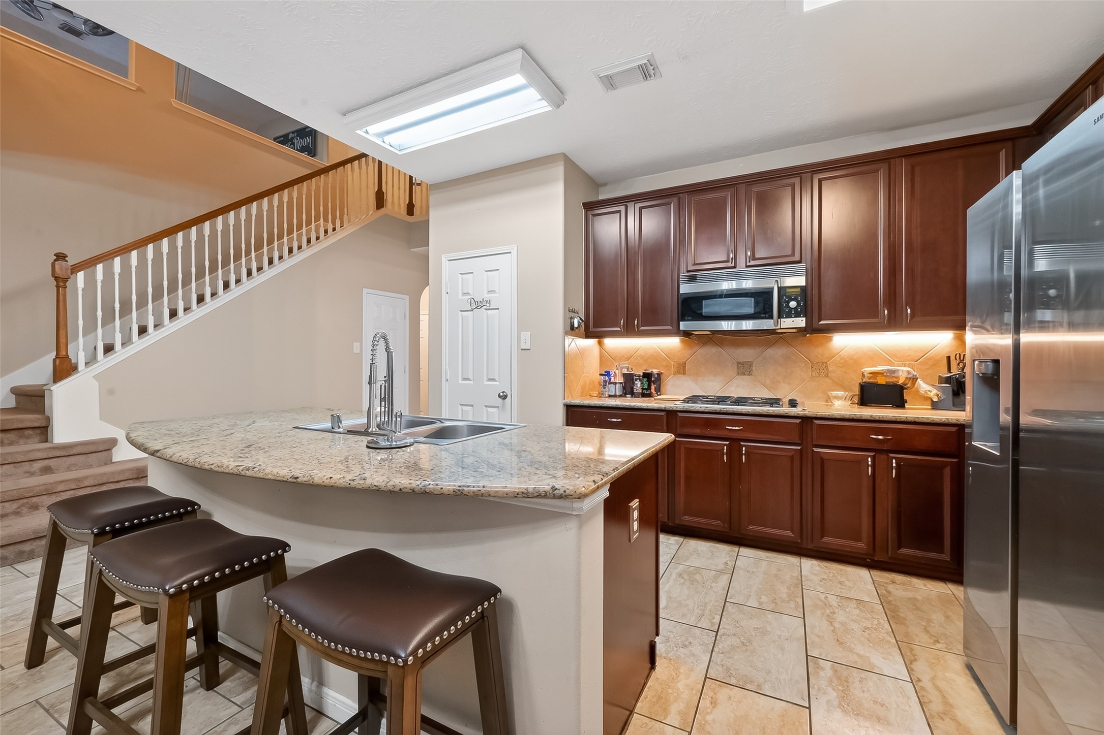 3203 Ruffin Green Court Fresno, TX 77545 - Photo 3 of 20 a kitchen with kitchen island granite countertop a sink and cabinets
