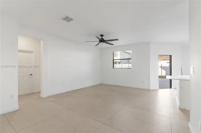 an empty room with a empty space and windows