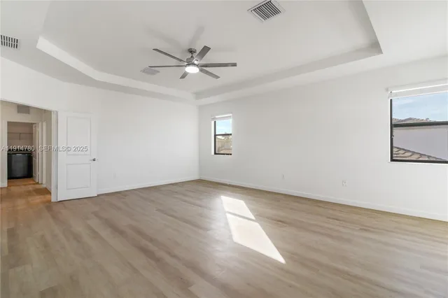a bathroom with a tub shower sink and mirror