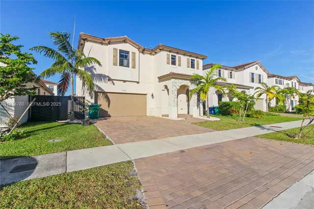 a front view of a house with a yard and garage