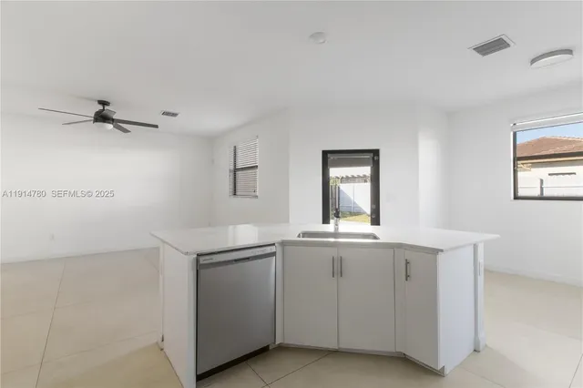 a kitchen with a sink and cabinets