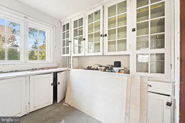 a room with furniture a rug toys and a window