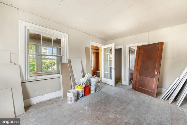 a room with gym equipment and windows