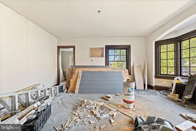 a living room with furniture large window and outdoor view