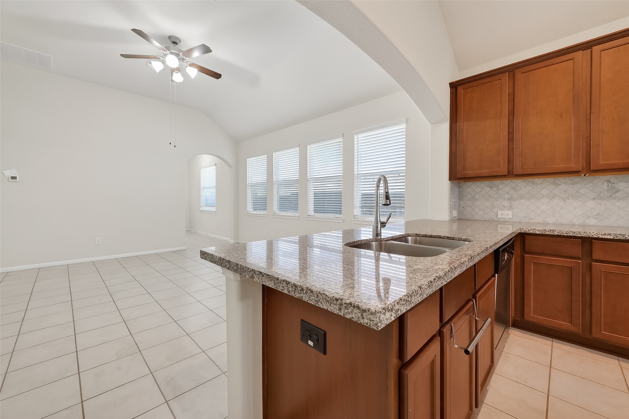 7631 Granite Terrace Lane Houston, TX 77083 - Photo 15 of 46 a kitchen with granite countertop a sink a counter top space and cabinets