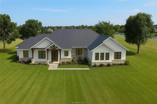 a front view of a house with swimming pool having outdoor seating