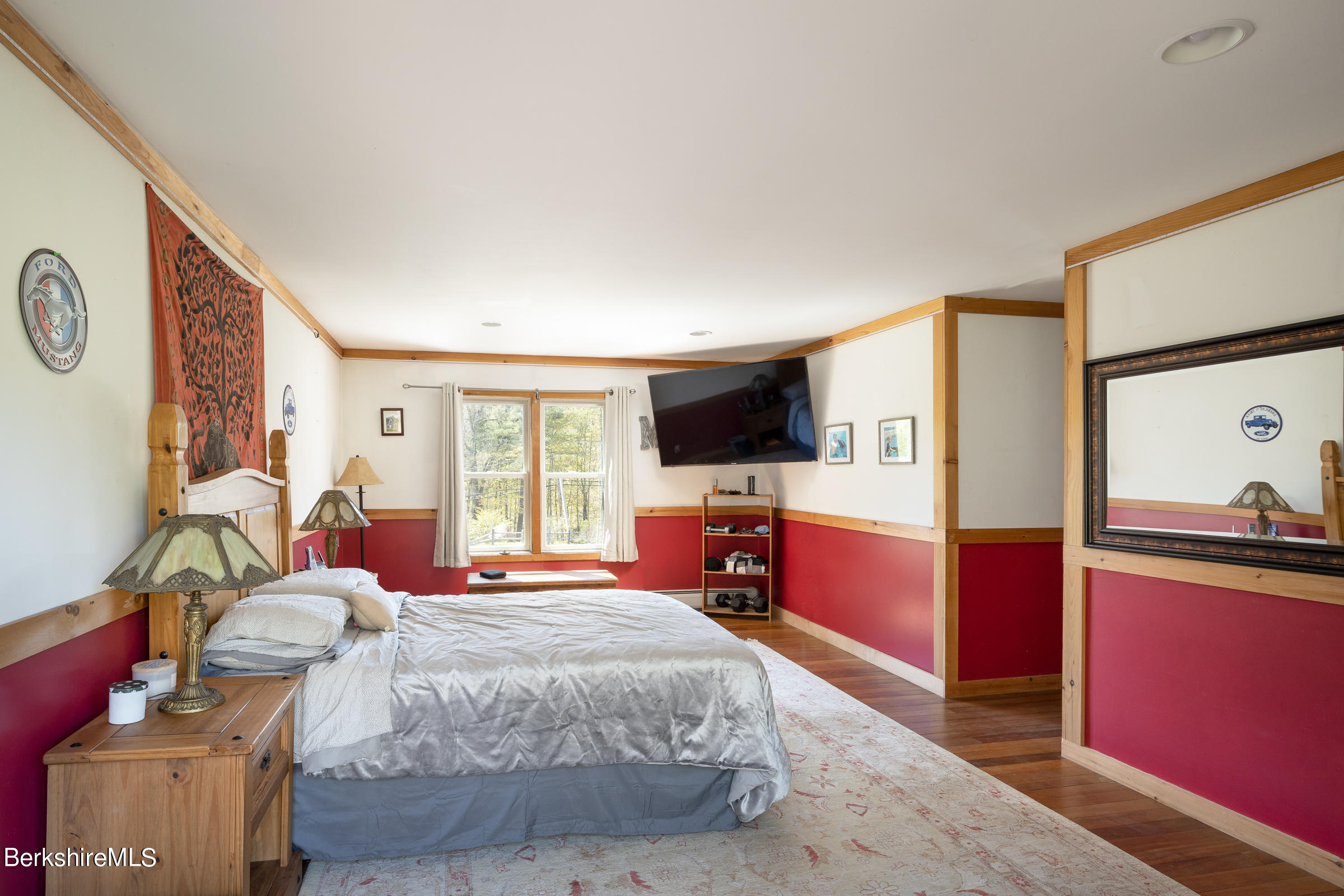 235 Main Road Monterey, MA 01245 - Photo 15 of 37 a bedroom with a bed and a flat screen tv