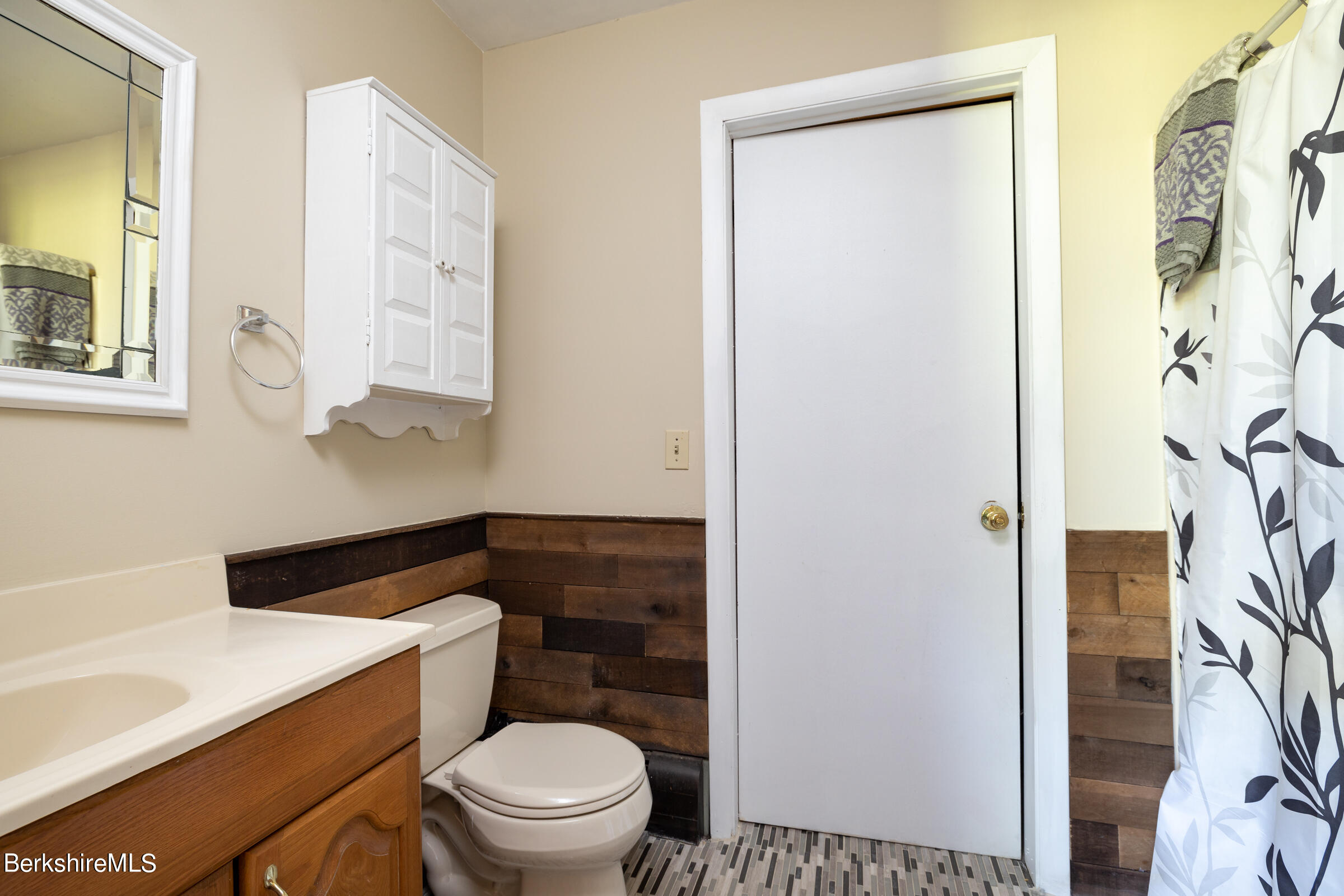 235 Main Road Monterey, MA 01245 - Photo 23 of 37 a white toilet sitting next to a bathroom sink and vanity
