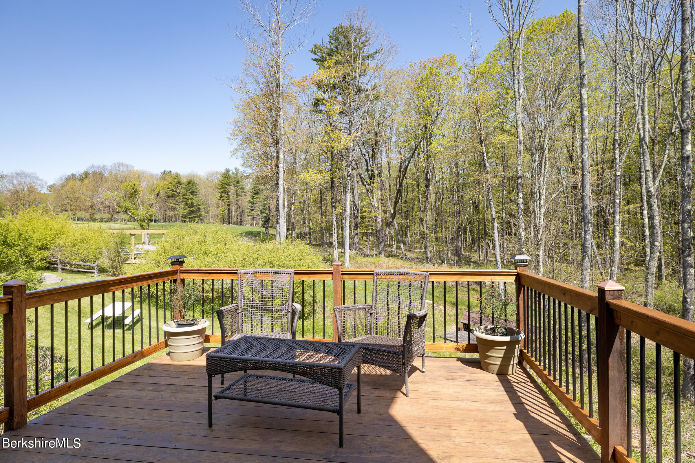 235 Main Road Monterey, MA 01245 - Photo 25 of 37 a view of a balcony with wooden floor and fence