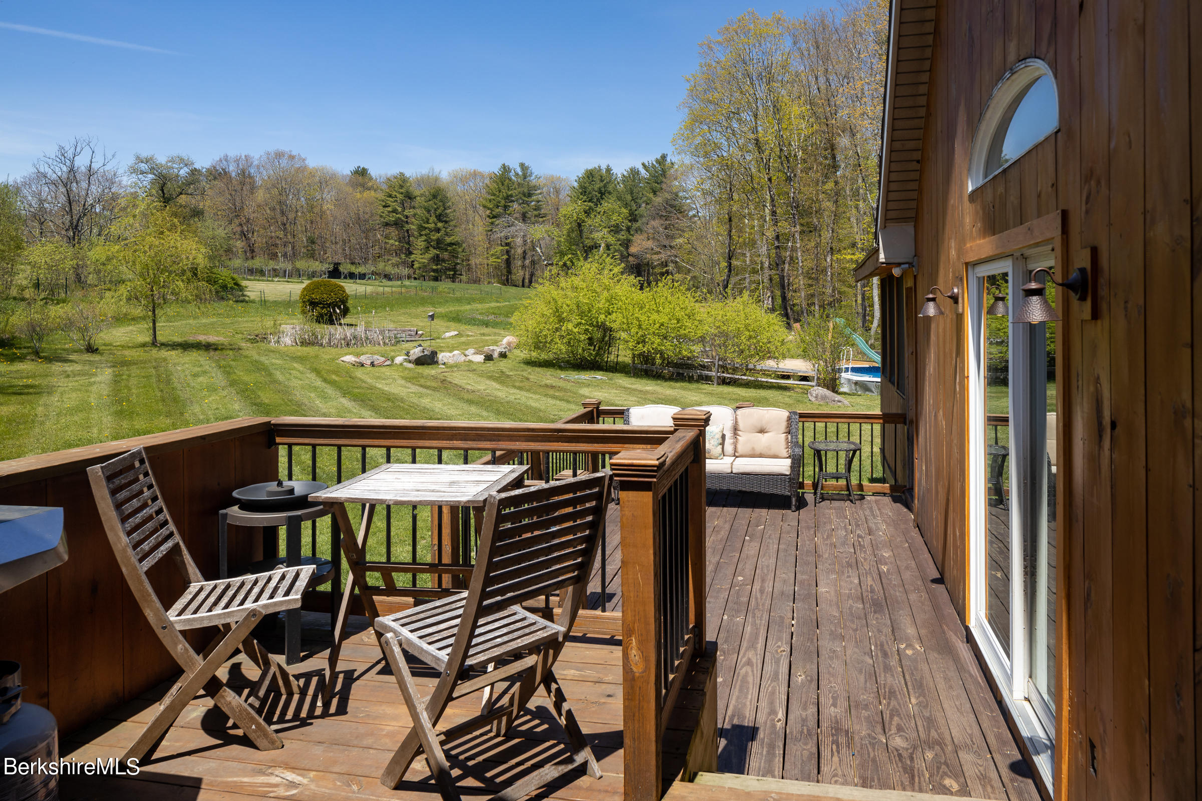 235 Main Road Monterey, MA 01245 - Photo 26 of 37 a view of a chairs and table on the balcony
