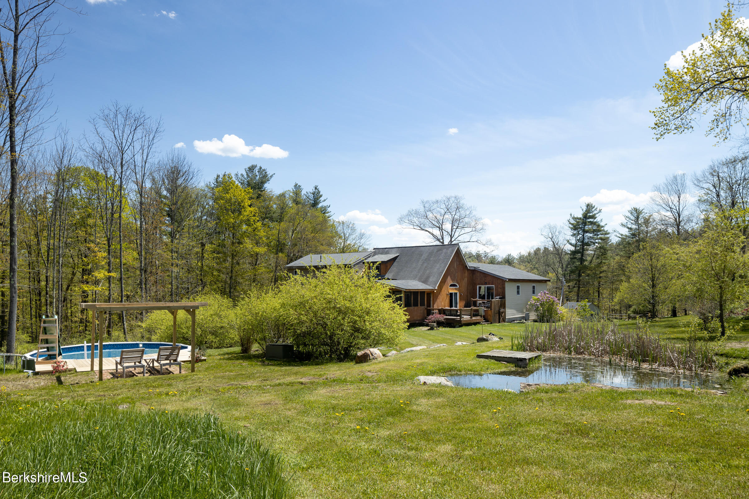 235 Main Road Monterey, MA 01245 - Photo 28 of 37 a view of a house with a big yard and large trees