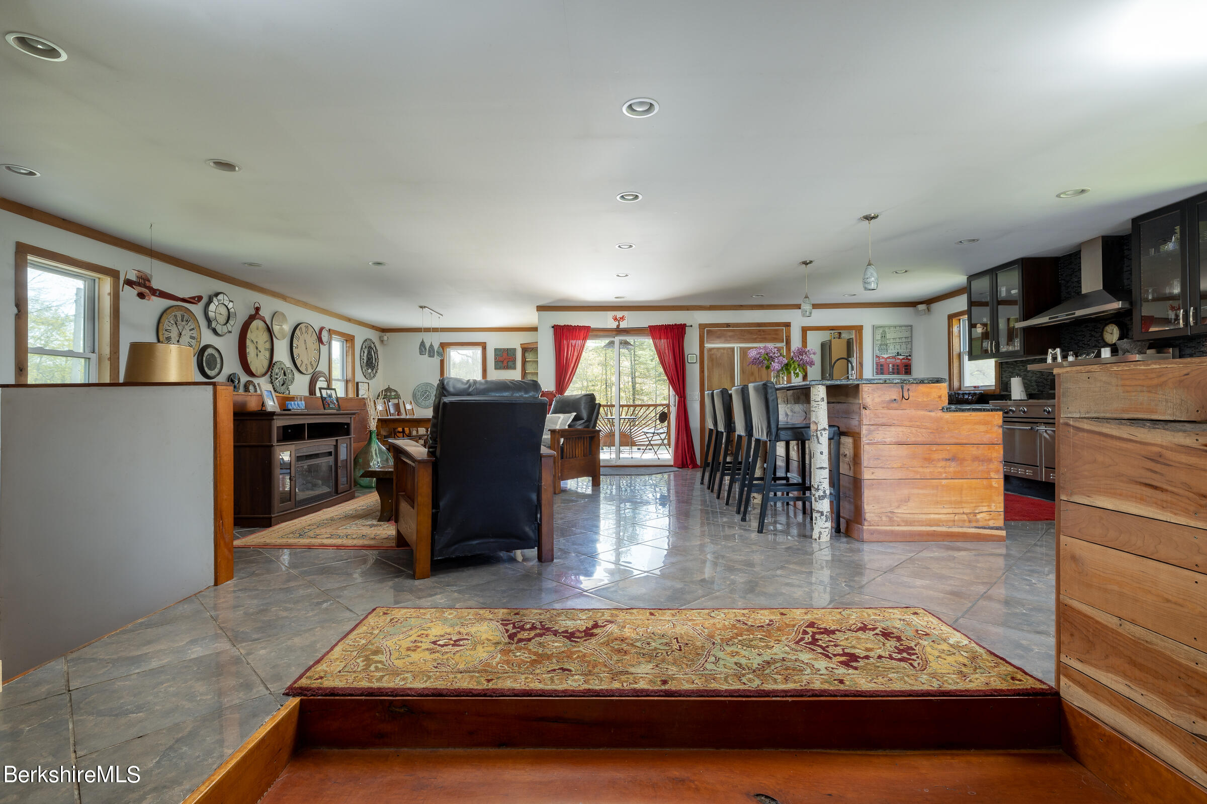 235 Main Road Monterey, MA 01245 - Photo 8 of 37 a living room with lots of furniture and kitchen view