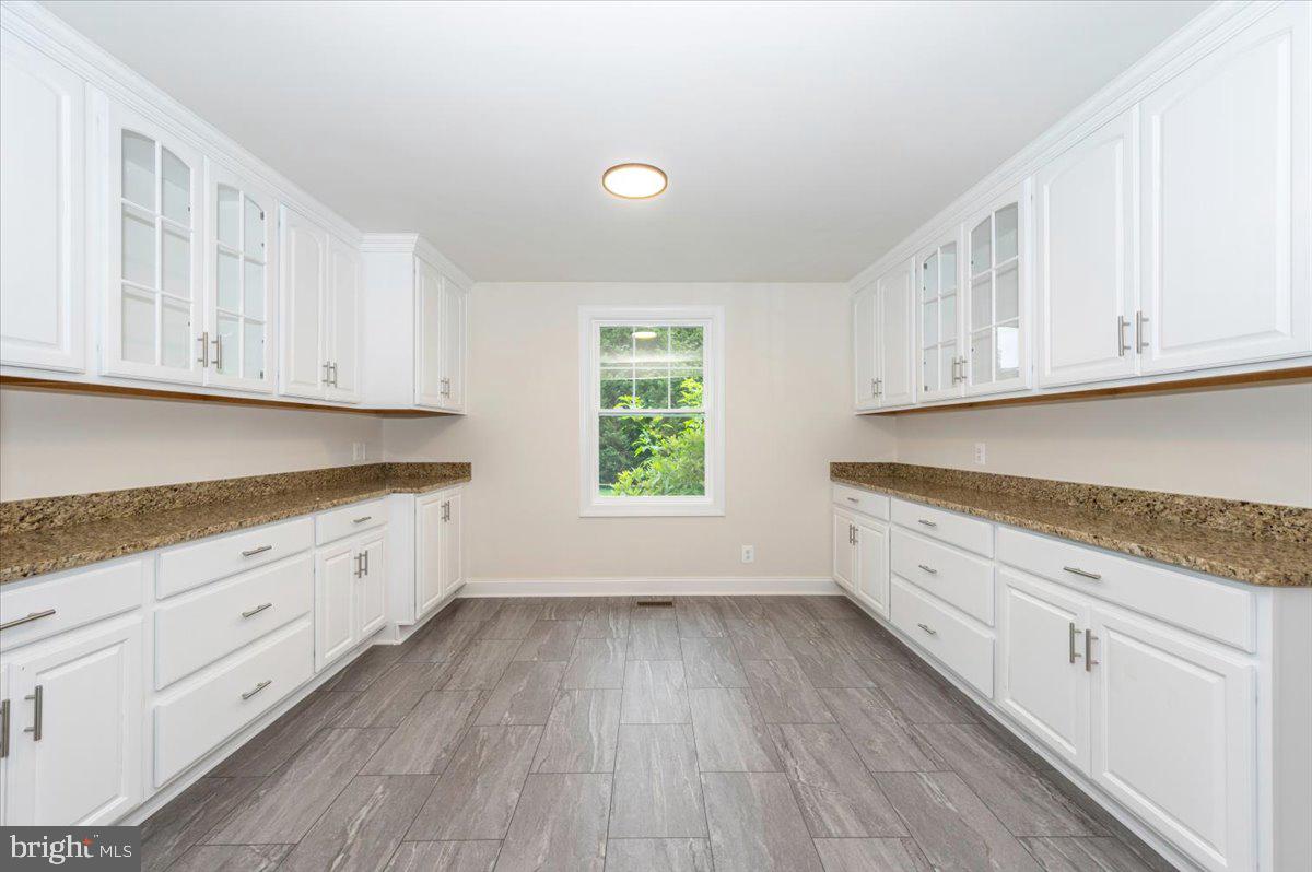 1802 Ridge Road Westminster, MD 21157 - Photo 11 of 47 a kitchen with granite countertop wooden cabinets and a window